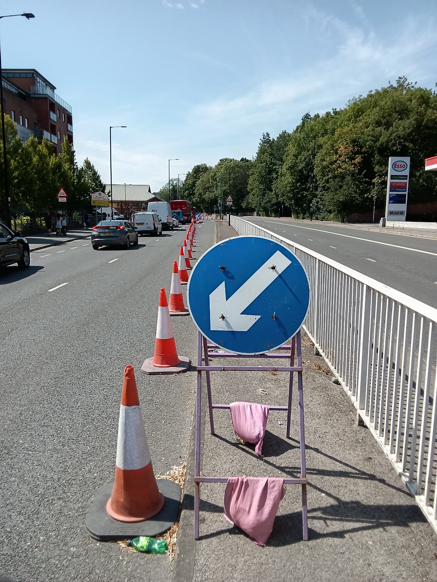 Coned lane closure with keep-left signage on a live urban carriageway