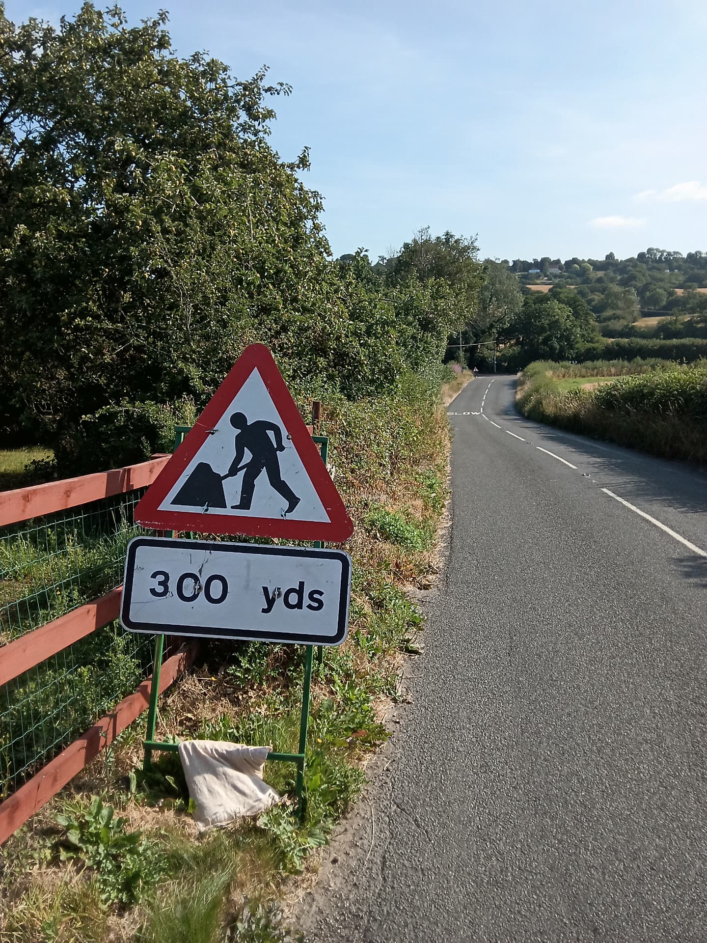 Roadworks warning sign on a rural road ahead of a live works site